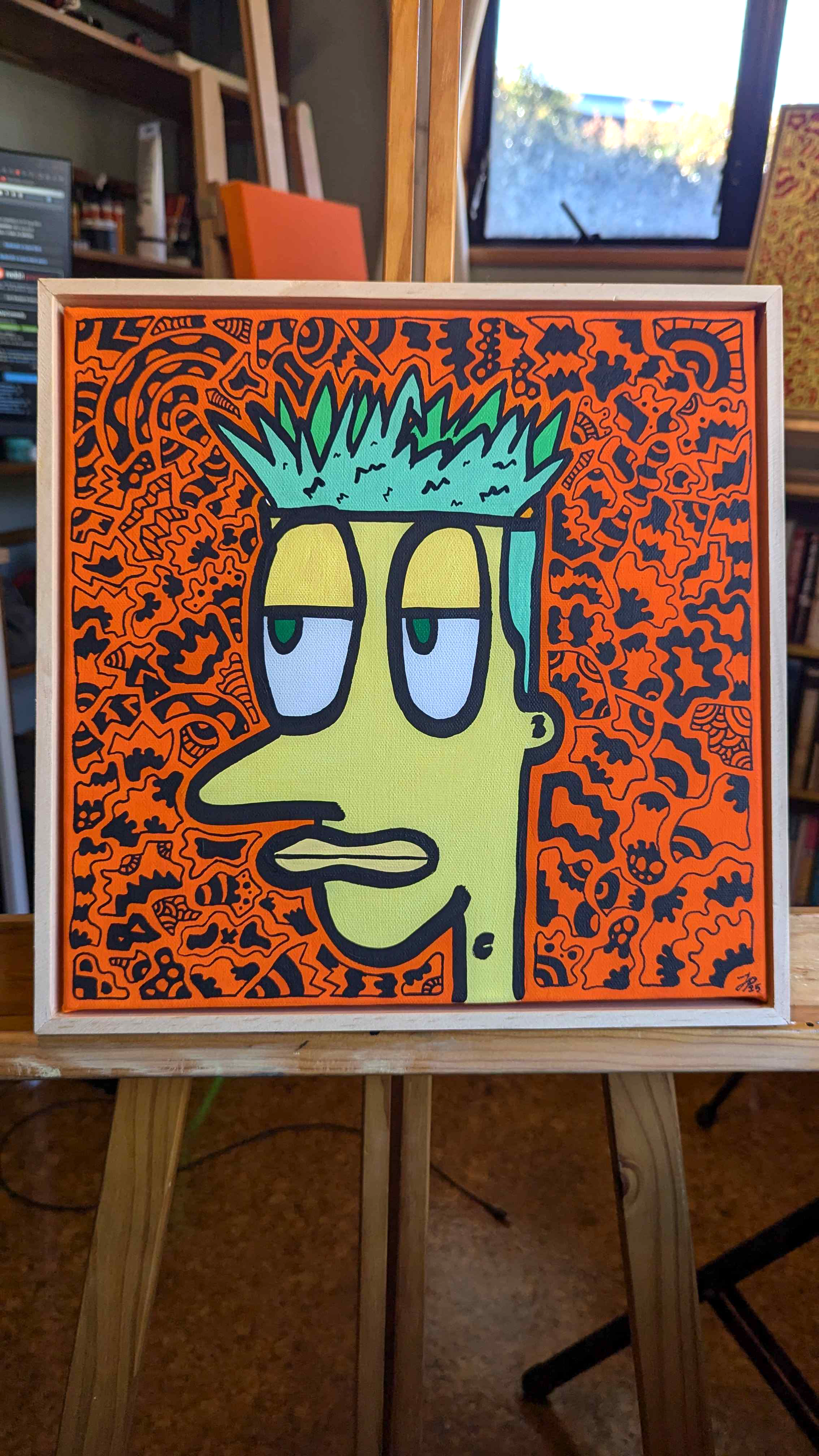 Colorful cartoon character painting on an easel with a patterned background