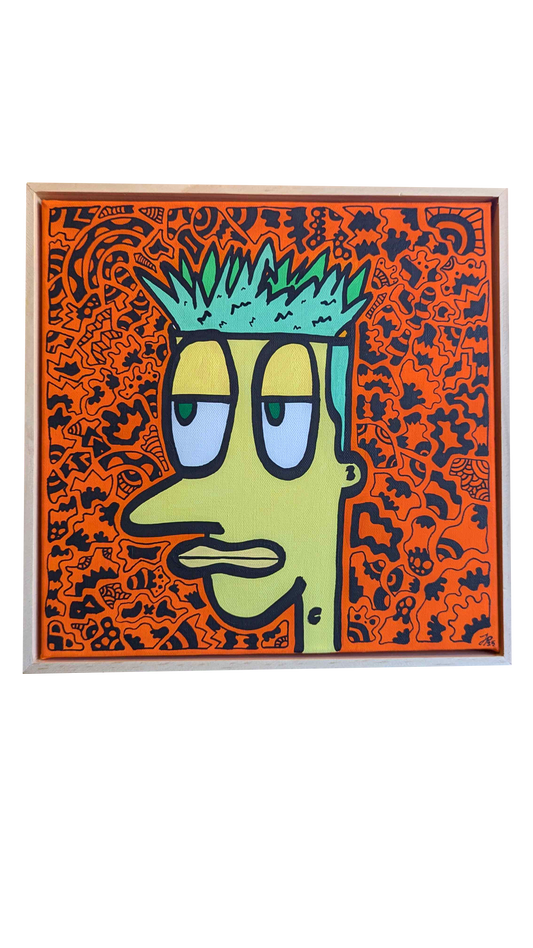 Framed artwork of a stylized face with green hair and blue eyes on an orange background.